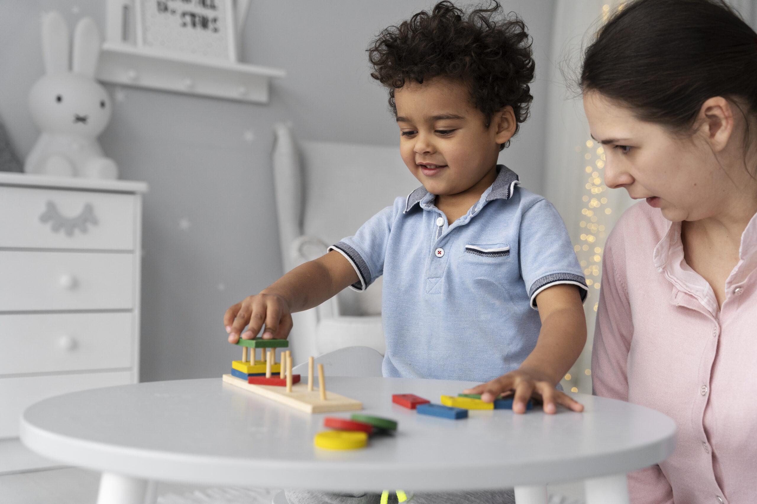 CLOSE UP CHILD ENJOYING DIDACTIC GAME