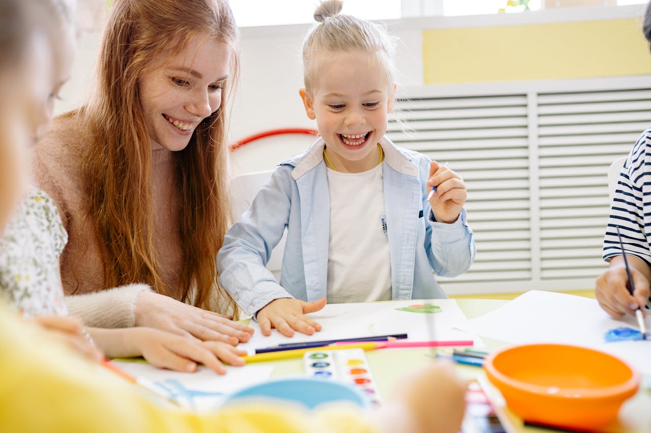 HAPPY LITTLE GIRL LEARNING TO PAINT